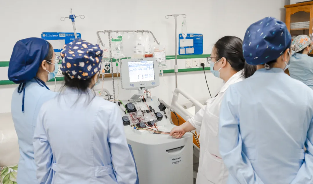 The cell therapy team prepares the apheresis machine